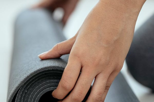 A detail shot of a yoga mat on a wooden floor.